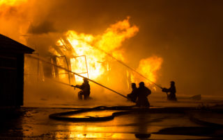 Firemen at work on fire | McCormick Insurance