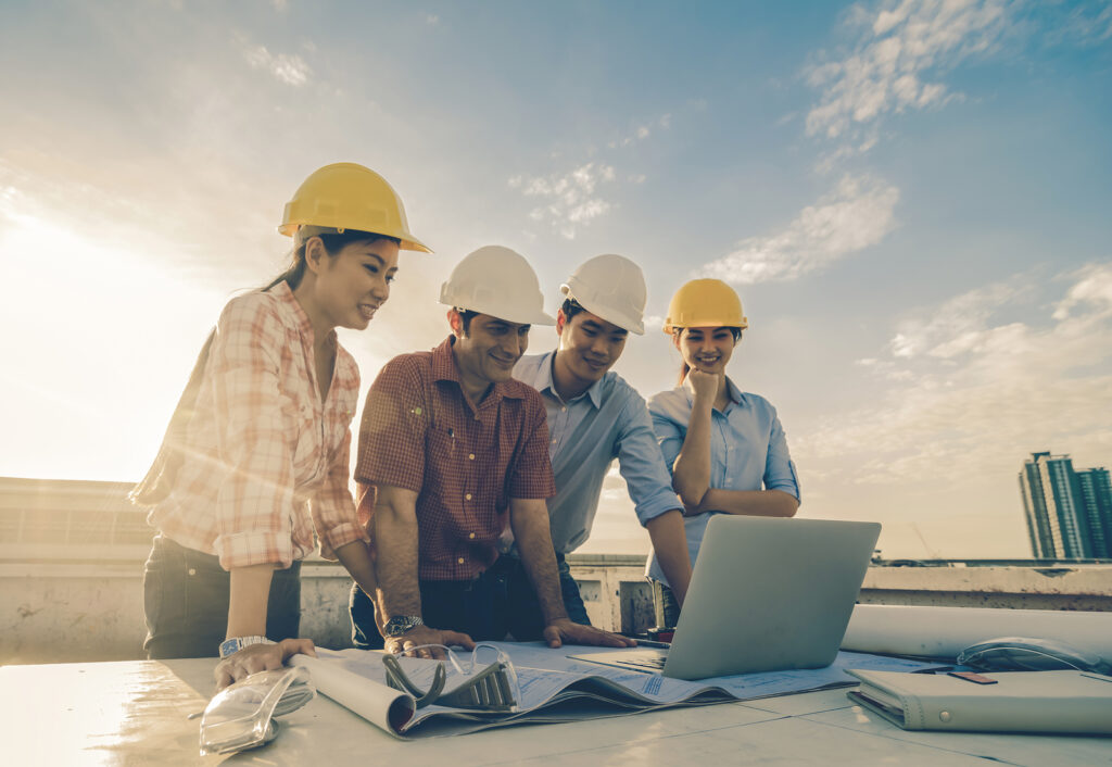 Happy Professional Construction Engineers Working With Corporate | McCormick Insurance Contractors